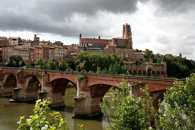 Albi featuring the Sainte-Cécile cathedral and the Pont Vieux (old bridge) over the river Tarn.